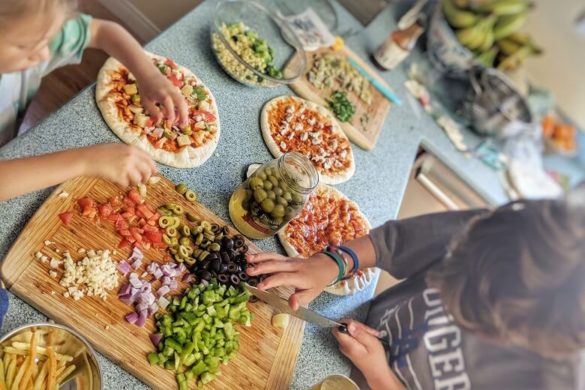 Kids cutting plant based foods and making vegan pizzas