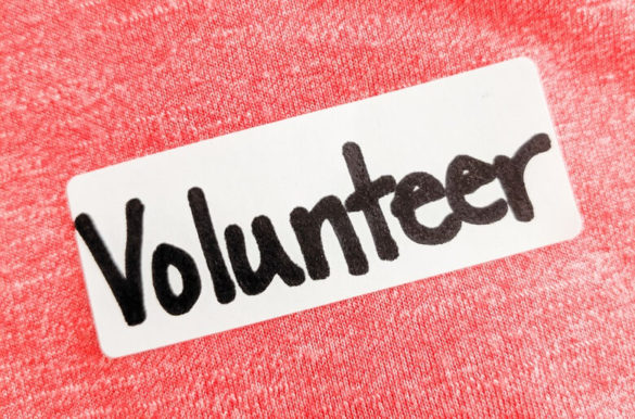 A label on a T-shirt that says "volunteer"