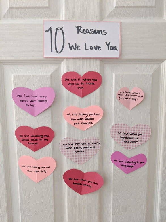 A door with the title 10 Reasons We Love You and 10 heart cut outs with different love notes for kids written on them to show the completed Valentine's Day craft for parents