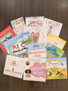 A lot of mindfulness books for kids spread out on a table