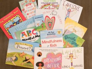 A lot of mindfulness books for kids spread out on a table