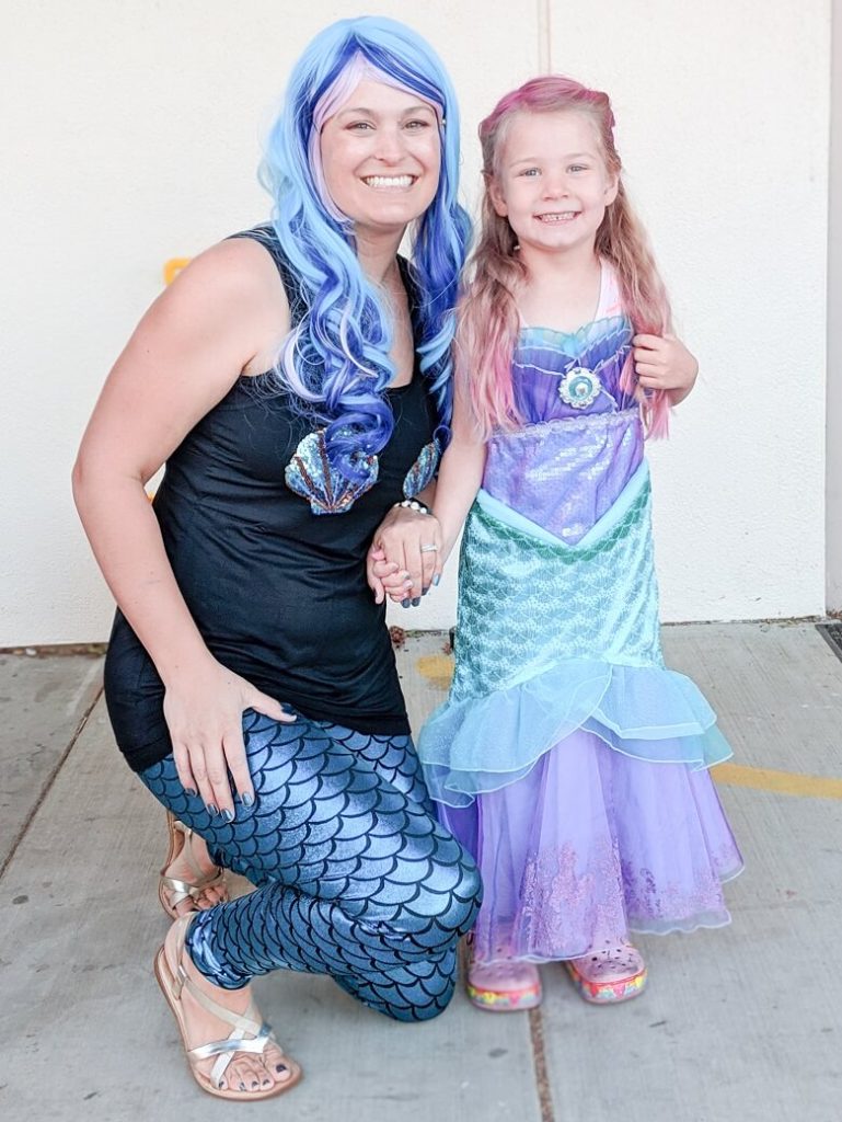 A school volunteer in her mermaid costume with her daughter who is also in a mermaid costume