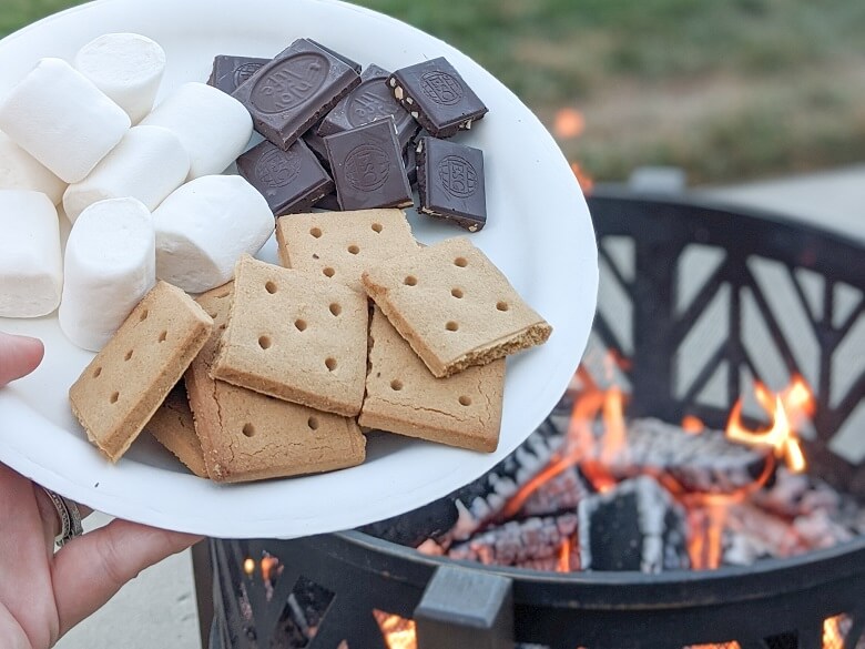 Ingredients for vegan s'mores of graham crackers, marshmallows, and chocolate