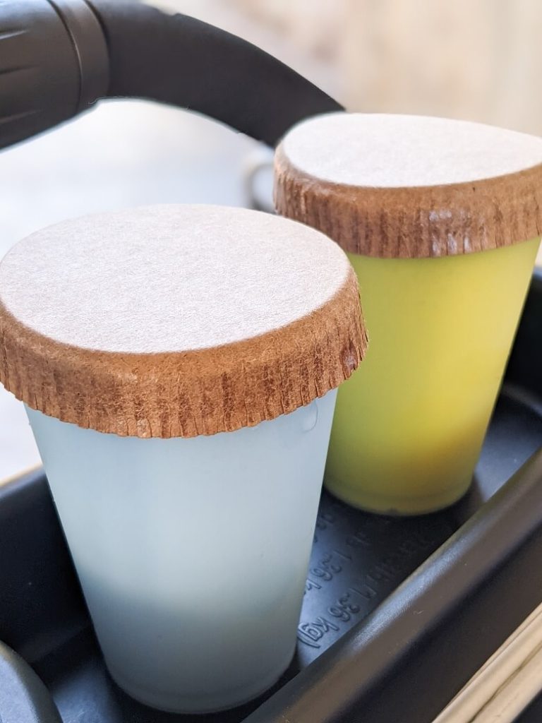 The blue and green milk next to each other in a stroller cup holder in Star Wars: Galaxy's Edge